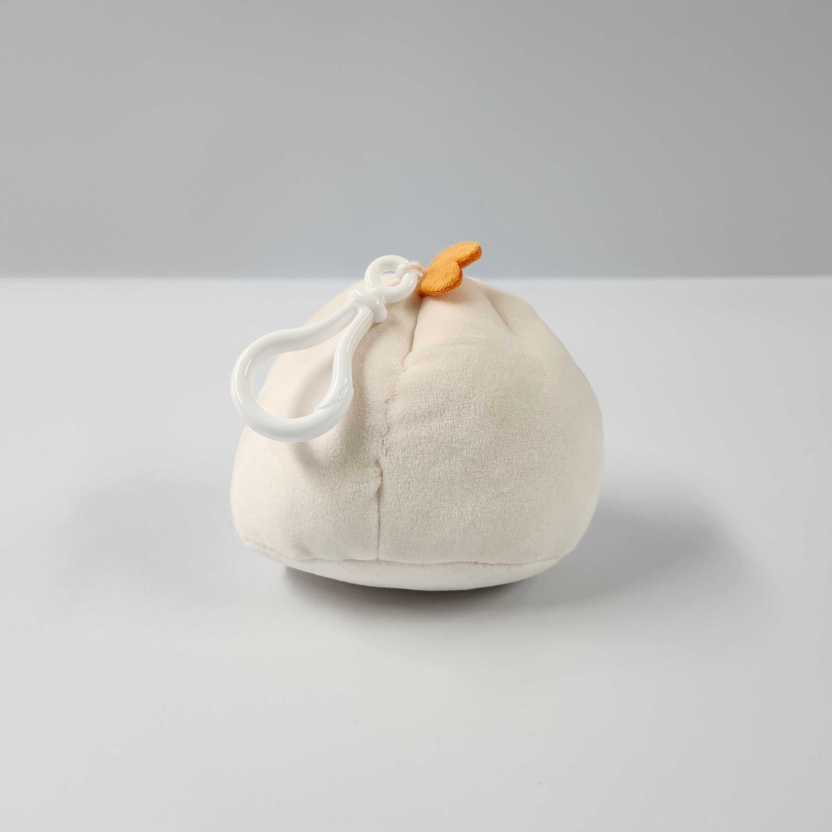 This is the back view of the mini plushie. The texture of the plushie is soft, and the comb of the chicken sits upwards but tilted sideways.